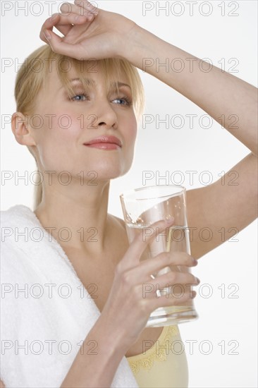 Woman with towel and water glass.