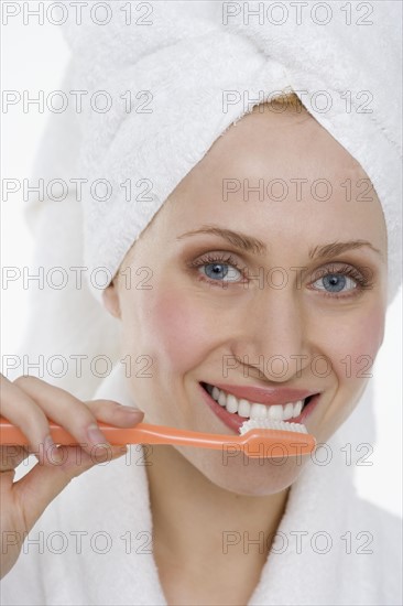 Woman brushing teeth.