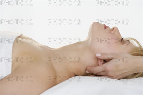 Headshot of woman getting massaged.