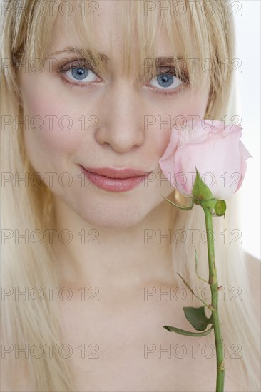 Woman with pink rose.