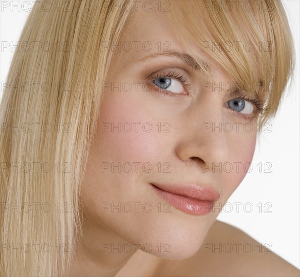 Headshot of blond woman looking sideways.