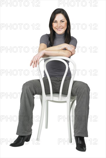 Portrait of a woman sitting on a chair.