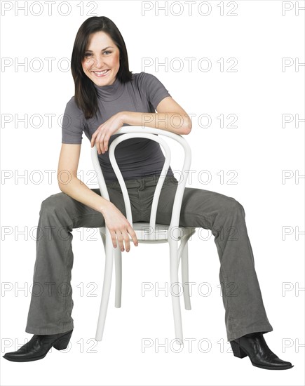 Portrait of a woman sitting on a chair.