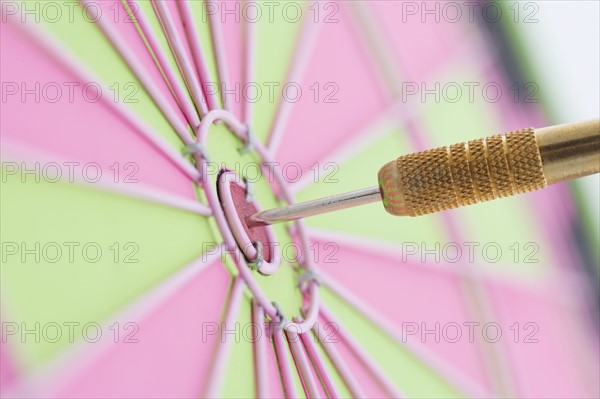 Closeup of dart in bulls eye.