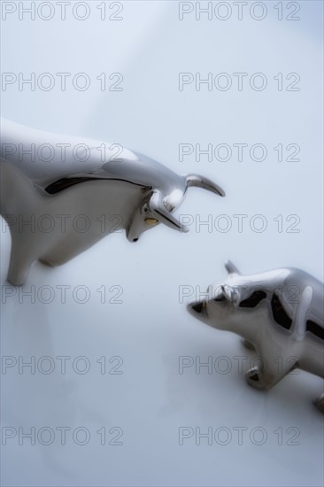 Bull and bear figurines facing-off.
