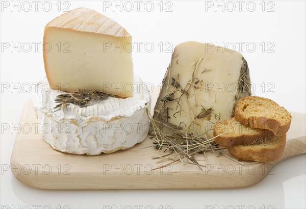 Cheeses on cutting board.