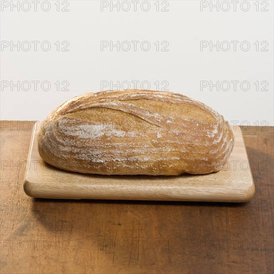 Loaf of bread on cutting board.