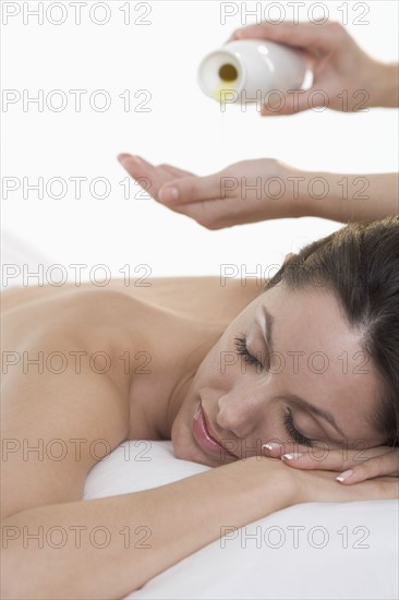 Woman face down with massage oil.