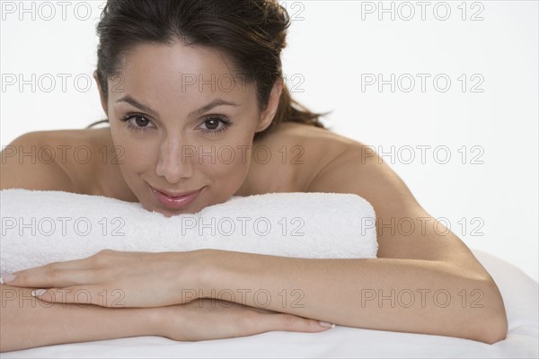 Woman with towel smiling seductively.