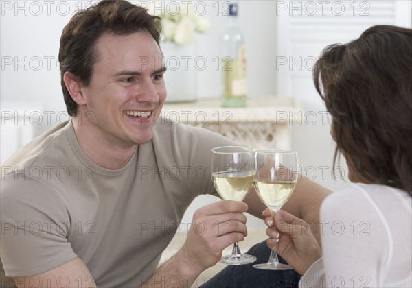 Couple with glasses of white wine.