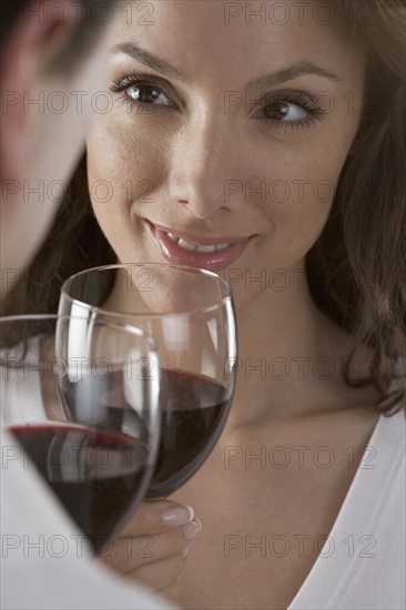 Couple holding wine glasses.