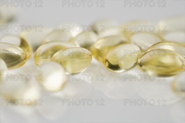 Closeup of several yellow gelcaps.