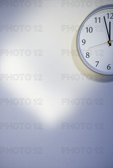 Bare wall with clock.