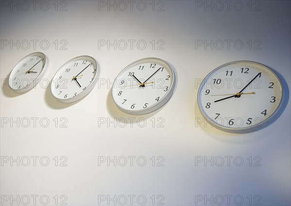 Row of clocks indicating different times.