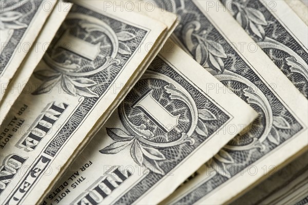 Closeup of stack of dollar bills.