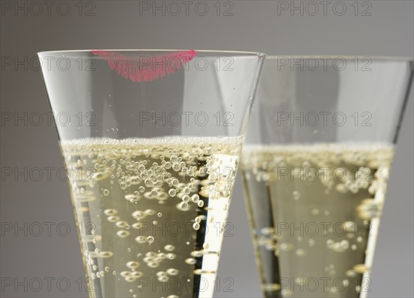 Closeup of champagne with lipstick print.