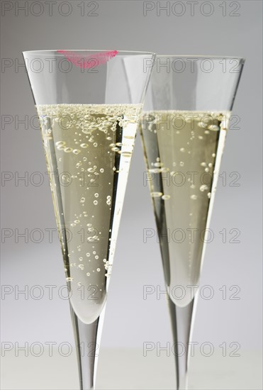 Champagne glasses with lipstick print.