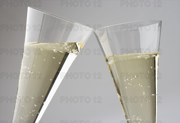 Closeup of toasting with champagne glasses.