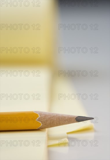 Sharpened pencil on pad of paper.