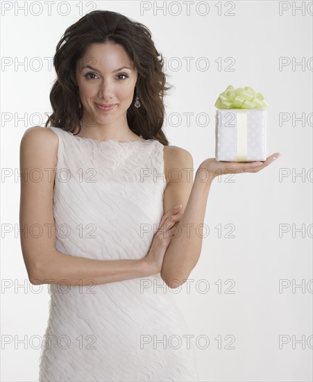 Woman in formal dress holding gift.