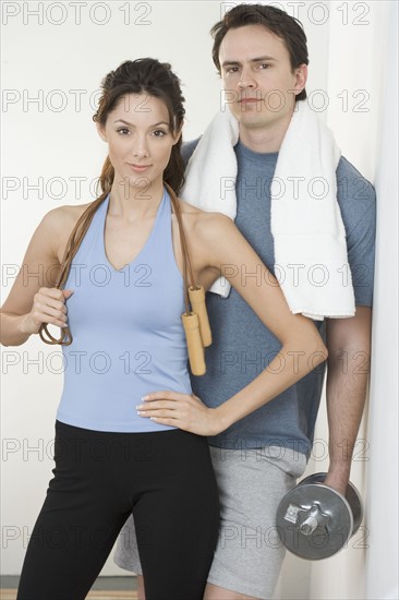 Couple with jump-rope towel and weight.