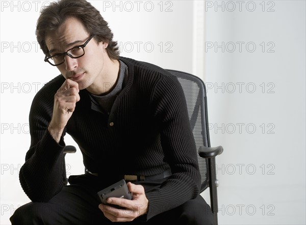 Professional man sitting thoughtfully.