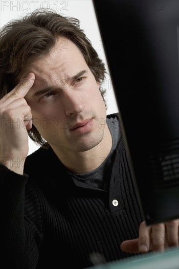 Perplexed man at computer.