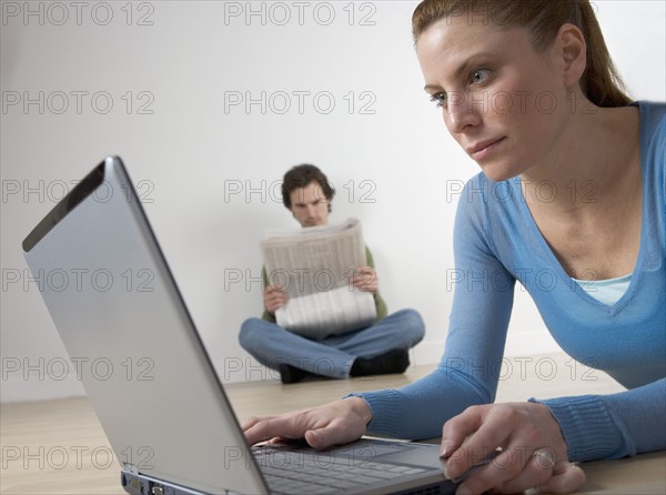 Couple with computer and paper.