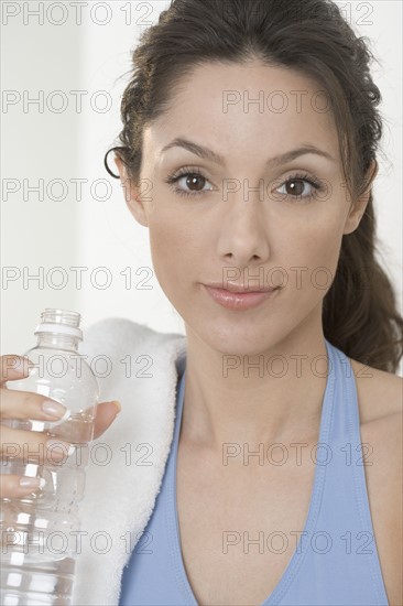 Smiling woman with water bottle.