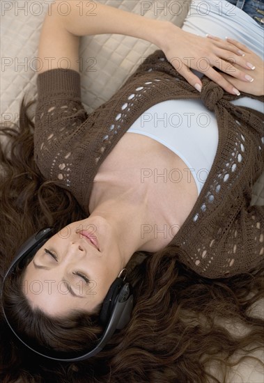 Woman resting with headphones on.