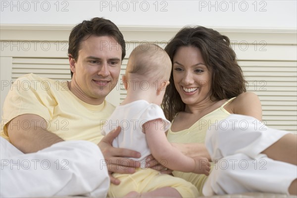 Couple relaxing with infant.
