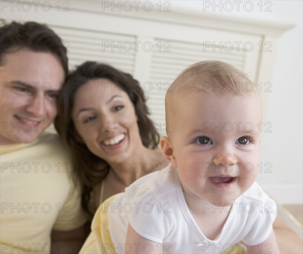 Closeup of baby with parents.