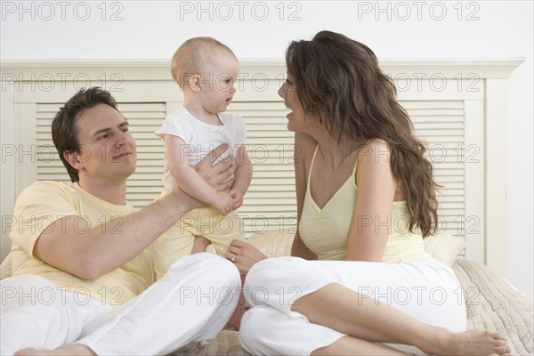 Mom talking to baby with dad.