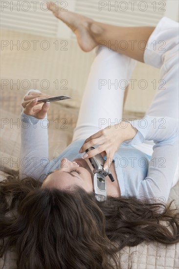 Woman with mobile phone and credit card.