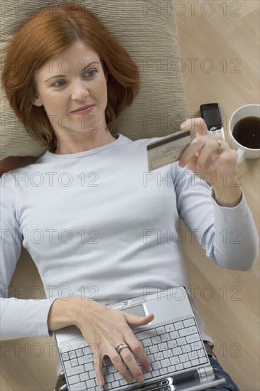 Woman with computer and credit card.