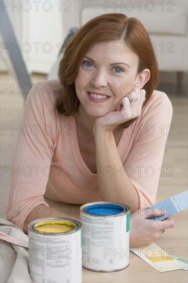 Smiling woman with paint samples.