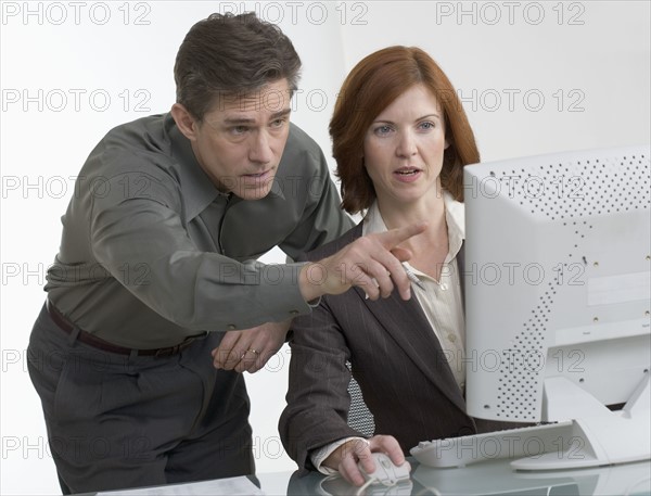 Business people looking at computer screen.
