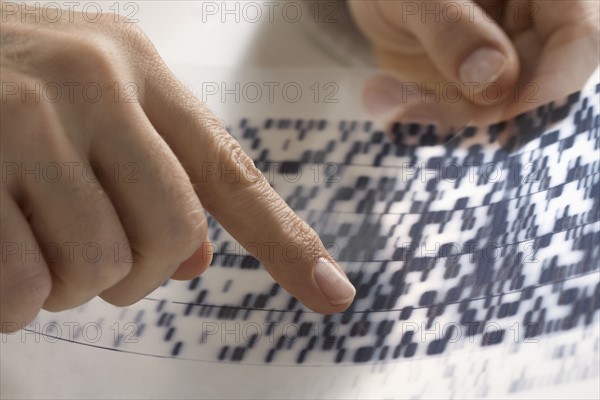 Closeup of hands pointing at data.