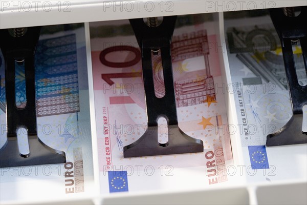 Closeup of Euros in cash register.