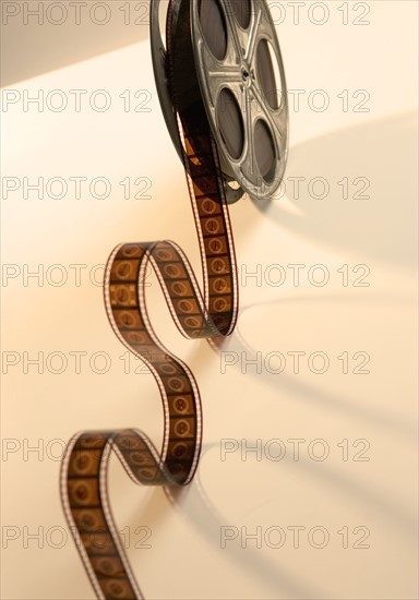 Movie film reel unrolling from above.