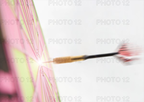 Closeup of dart hitting bulls eye.