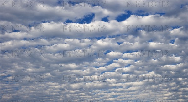 White clouds covering blue sky.