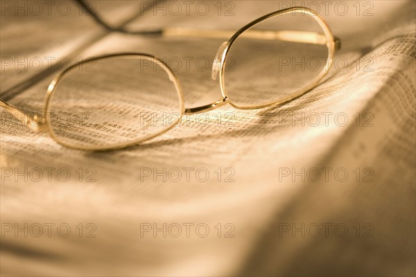 Still life of reading glasses and documents.