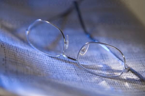 Still life of reading glasses and documents.