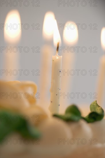 Lit candles on a birthday cake.