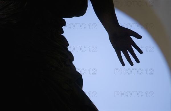 Silhouette of hand on statue Florence Italy.