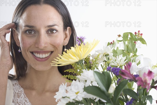 Woman holding bouquet of flowers.