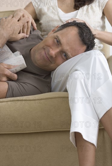 Man resting head on woman's lap.