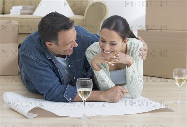 Couple looking at blueprints.