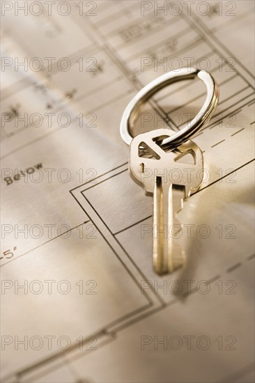 Still life of a key on blueprint .